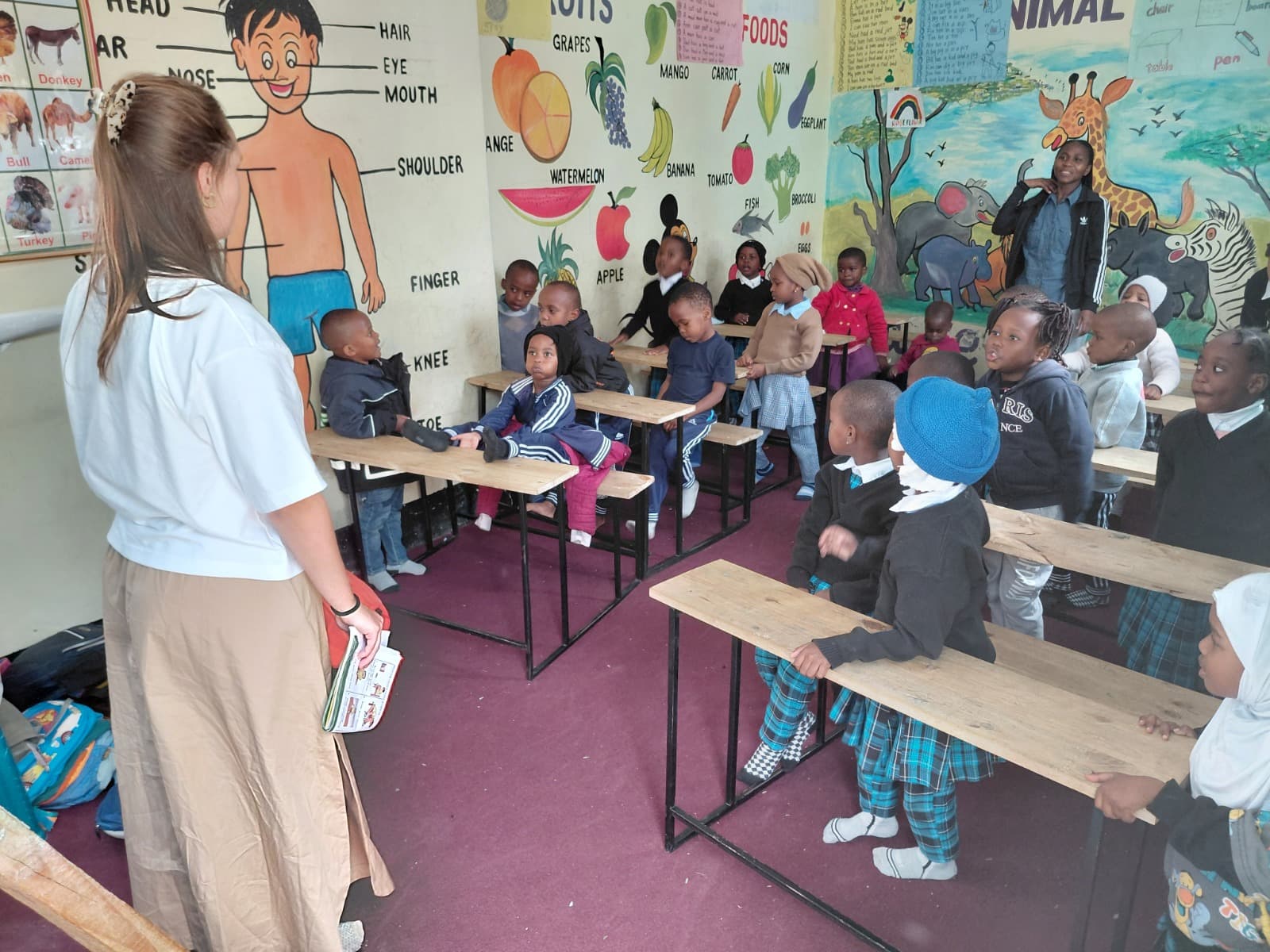 Volunteer reading with a child at Rose Flower Daycare